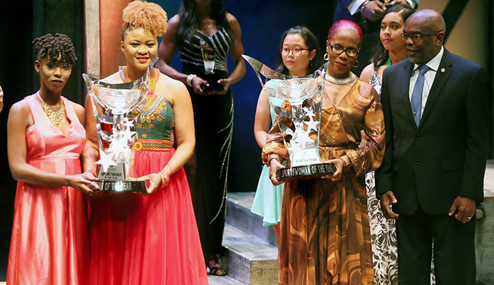 First Citizens Sports Award Winners: Men’s champ Jereem Richards, represented by his sister Brittney (left) holds his trophy along with acting Minister of Sport and Youth Affairs Dr Nyan Gadsby-Dolly (second from right) while Michelle-Lee Ahye, represented by her mother Raquel (second from right) holds her trophy, while chairman of the First Citizens Sports Foundation Dr Keith Clifford (right) looks on. Photo: Azlan Mohammed