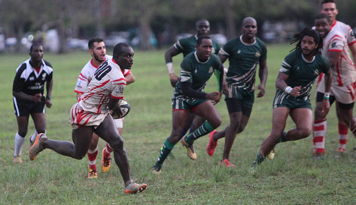 A Caribs player makes a darting run against Harvard yesterday at the Queen's Park Savannah.