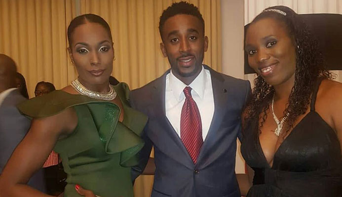 National volleyballers Jalicia Ross,left, and Kelly-Anne Billingy,right, pose for a picture with 400m hurdler, Jehue Gordon,at the Diplomatic Centre, St Ann's, during a function hosted by Prime Minister Dr Keith Rowley, for TT athletes who competed at the recent CAC Games, in Colombia.