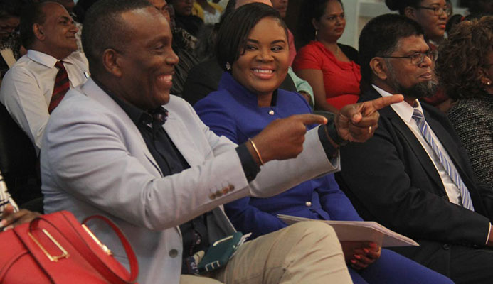 Minister of Sport and Youth Affairs Shamfa Cudjoe,centre, shares a laugh with Member of Parliament for Tunapuna Esmond Forde,left, at the Rewards, Recognition and Cheque Presentation Ceremony, at the National Racquet Centre, Tacarigua yesterday.