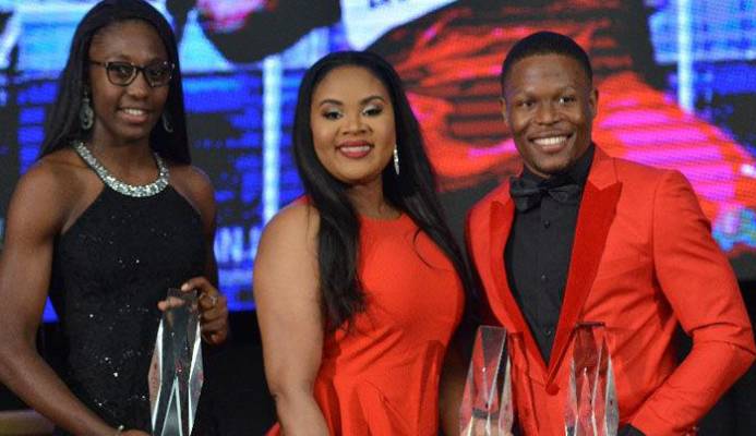 WINNERS’ ROW: Track sprinter Shaniqua Bascombe, left, and cyclist Nicholas Paul, right, pose for a photo-op with Minister of Sport and Youth Affairs, Shamfa Cudjoe, during the Trinidad and Tobago Olympic Committee’s 25th Annual Awards Ceremony, held at the Hyatt Regency in Port of Spain, last evening. Bascombe copped the TTOC Junior Sportswoman of the Year award while Paul was named Sportsman of the Year. --Photo: JERMAINE CRUICKSHANK