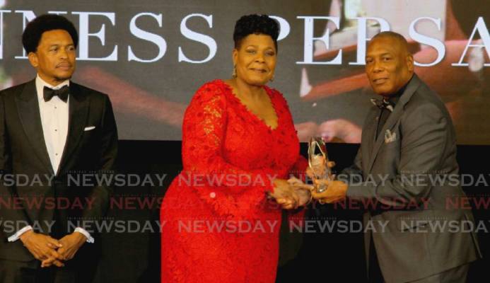 President Paula-Mae Weekes (centre) presents the Alexander B Chapman Award to NAAA president Ephraim Serrette (right), on behalf of veteran track and field coach Gunness Persad, at the TTOC award ceremony, at the Hyatt Regency Hotel, Port of Spain on Sunday. Also in photo is TTOC president Brian Lewis. PHOTO BY ROGER JACOB. - ROGER JACOB