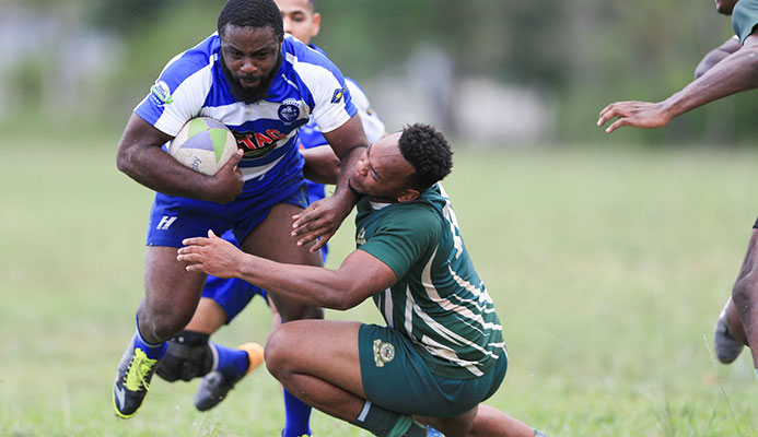 Northerns' Mark Roberts pommels Harvards' Kyle Strachan during the Solomoon Hochoy Ruggerama Tournament at the Queen's Park Savannah. Northerns won 5-0 in sudden death.  Allan V. Crane