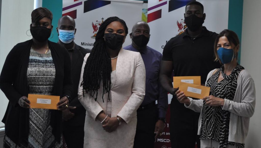 Minister of Sport and Community Development Shamfa Cudjoe (front second left) with Pat Maurice-Thompson, representative for sprinter Jereem Richards (front left), Tracy Carter, representative for swimmer Dylan Carter (front right), Director of Physical Education and Sport Division, Gabre McTair (left back), Ephraim Serrette, sport advisor to the Minister (centre back), and boxer Nigel Paul (second right back). - MINISTRY OF SPORT AND COMMUNITY DEVELOPMENT