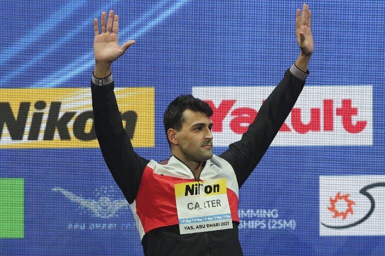 RECORD-SETTER: Dylan Carter of Trinidad and Tobago stands on the podium after winning silver in the 50 metres butterfly final at the World Short Course Swimming Championships in Abu Dhabi, United Arab Emirates, yesterday. —Photo: AP