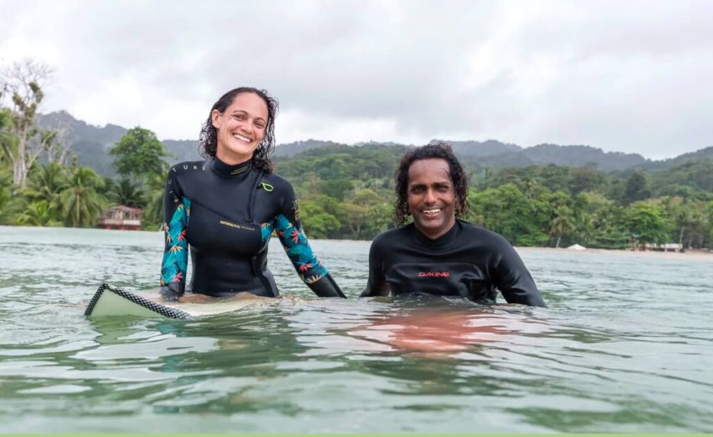 Manuela Giger instructs a surf therapy participant on how to stand on a surfboard. PHOTO COURTESY OMARION BUTLER. -