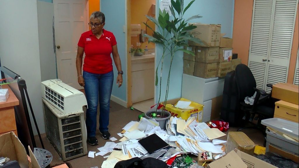 T&T Olympic Committee president Diane Henderson looks at the ransacked office at Olympic House on Abercrombie Street, Port-of-Spain, on Friday. (Image via: guardian.co.tt)