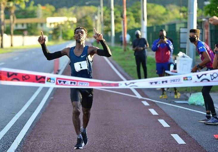 TRIUMPHANT: Guyana’s Kelvin Johnson raises his arms in victory after taking the 2022 elite category of the Trinidad and Tobago International Marathon (TTIM) last year in Chaguaramas. Johnson will defend his crown on a new route tomorrow for the 41st edition of the TTIM.  —Photo: ISHMAEL SALANDY (Image obtained via trinidadexpress.com)