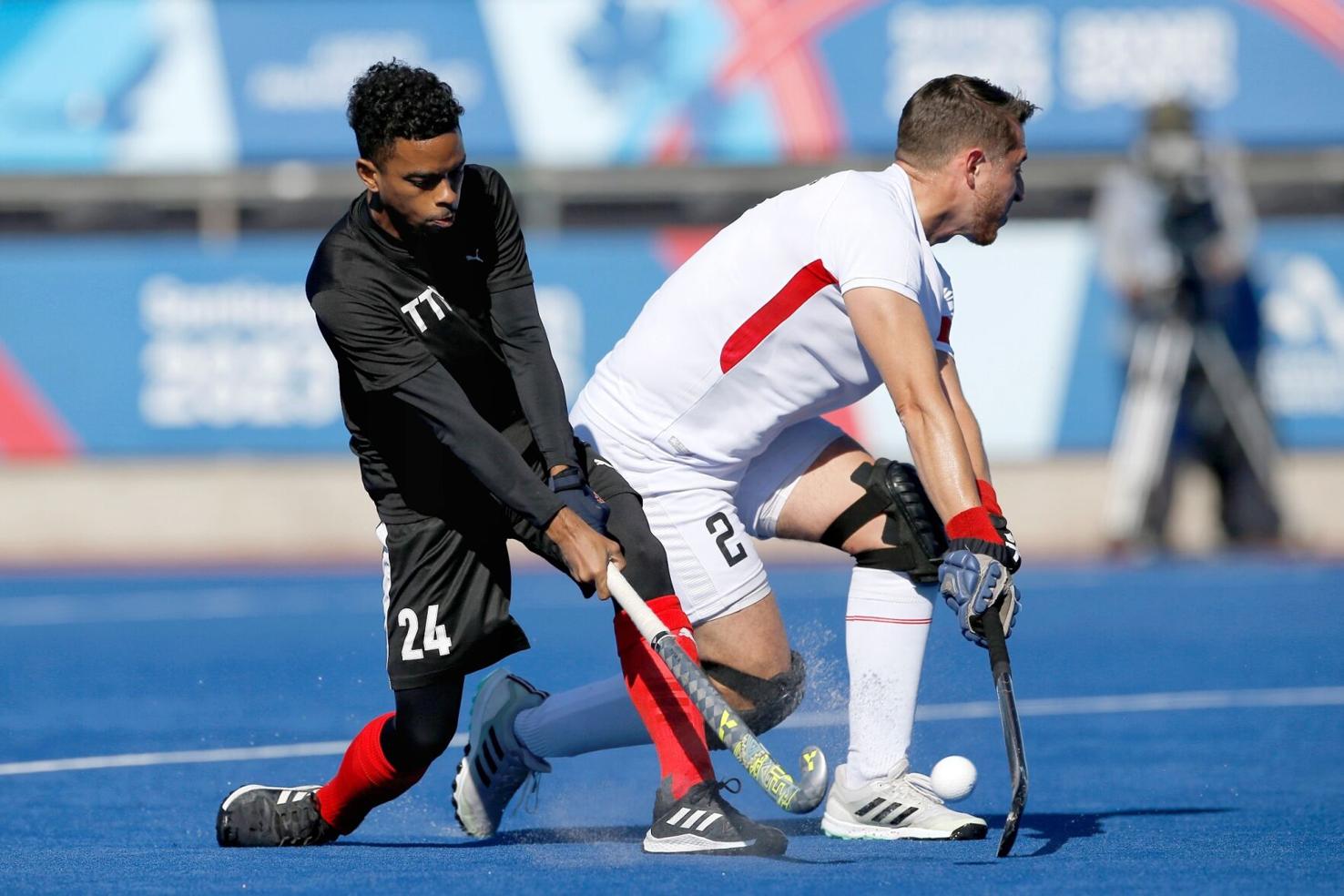 CLASH: TTO’s Ethan Reynos, left, attempts to slap the ball up-field as Peru’s captain Vincenzo De Martis closes him down during their 7th to 8th place playoff match at the Centro Deportivo de Hockey Césped yesterday. TTO pummelled Peru 10-0 to conclude their Santiago 2023 Pan American Games campaign on a high.  —Photo: Photosport/Panam Sports (Image obtained at trinidadexpress.com)