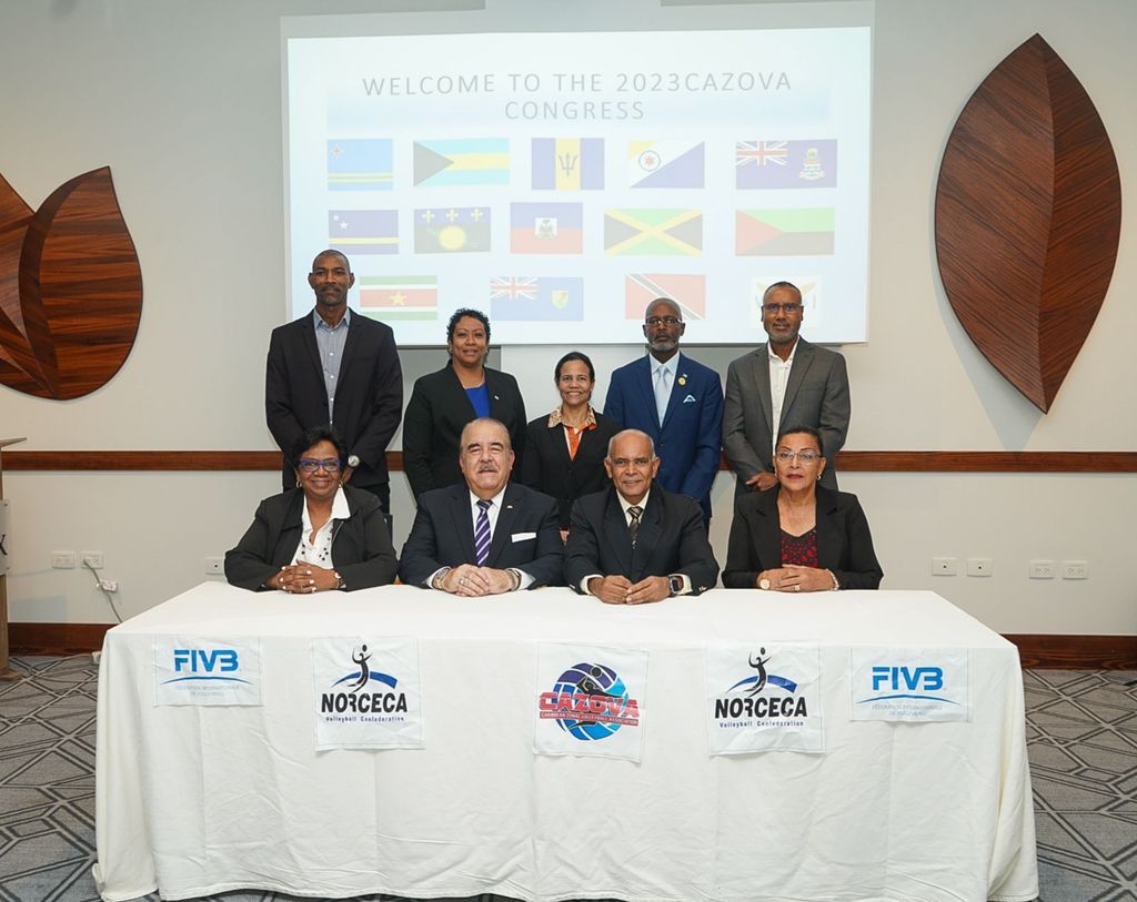 T&T's Mushtaque Mohammed, second from right at the table, was returned as president of the Caribbean Zonal Volleyball Organisation (CAZOVA), poses with fellow board members at the body’s congress held at The Brix Hotel, Coblentz Avenue, yesterday. (Image obtained at guardian.co.tt)
